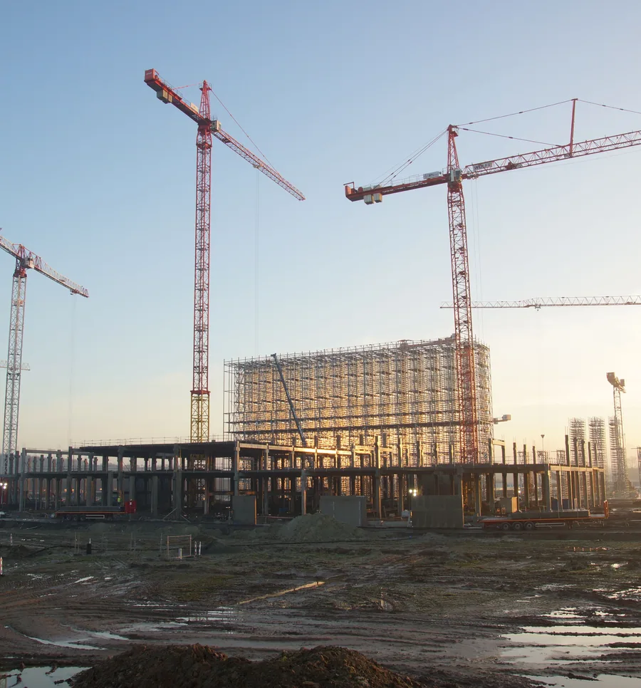 Tower cranes erecting a multi-storey steel structure.