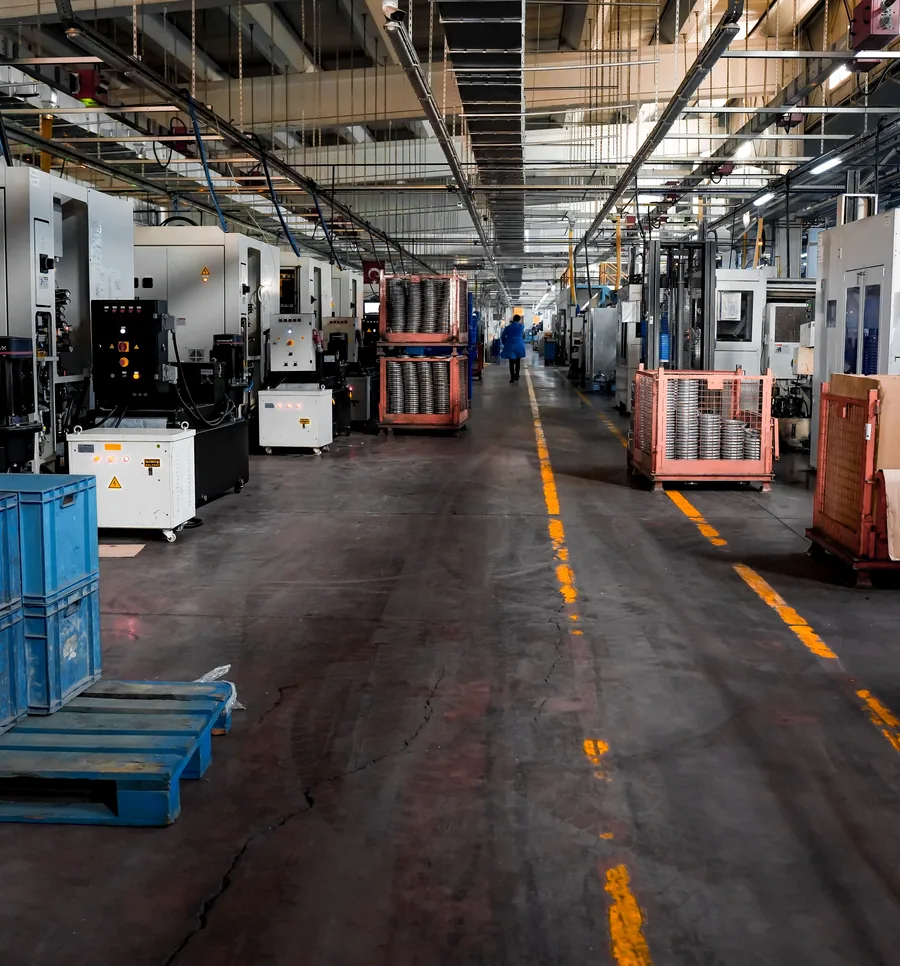 A working factory floor with machinery bays and marked circulation aisles.